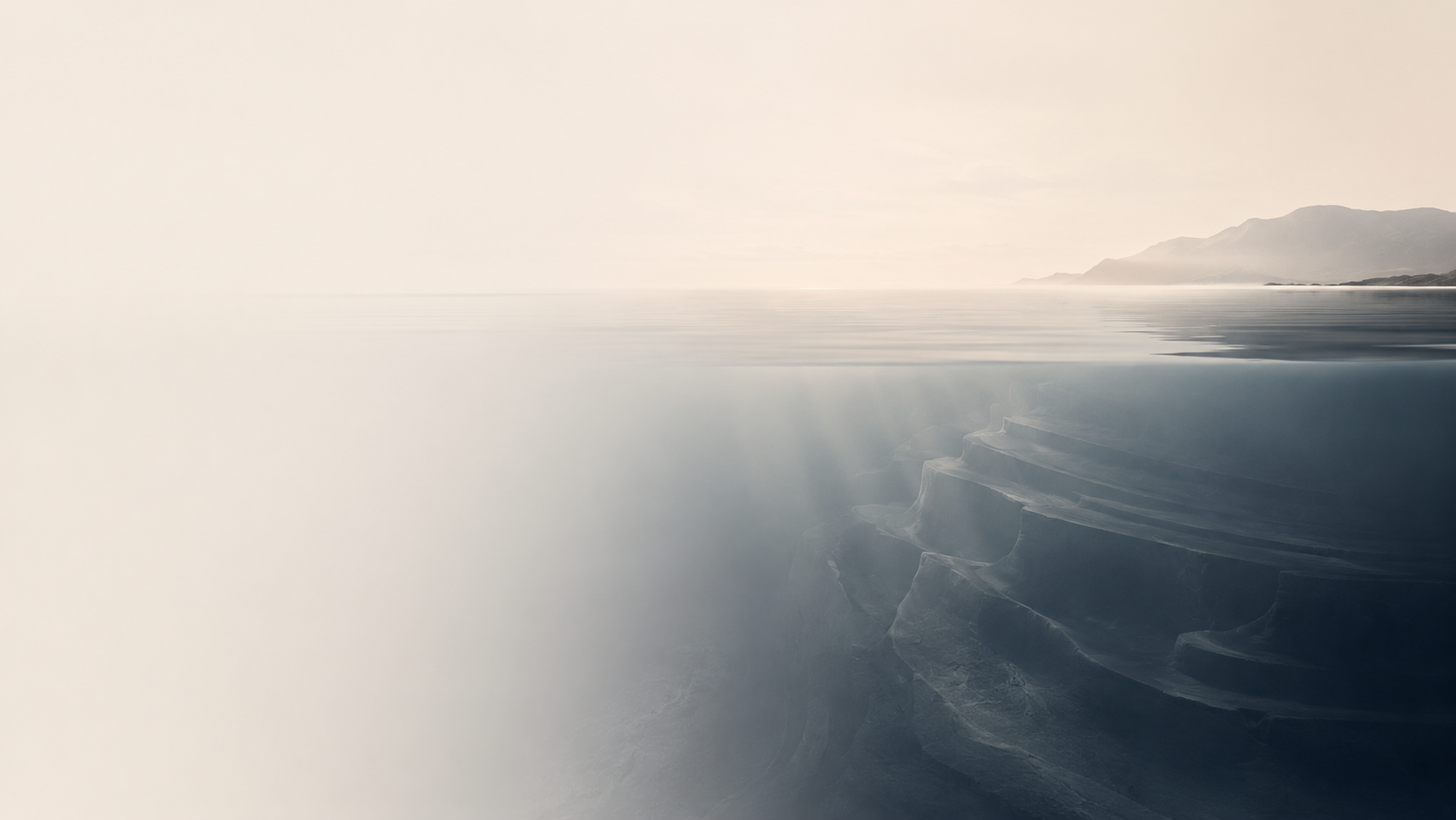 A calm water surface revealing a deeper submerged landscape below.