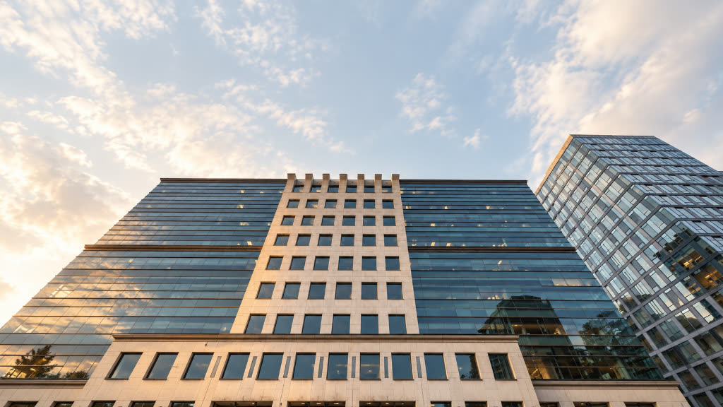 The firm's office building in downtown Seattle, photographed from below at golden hour